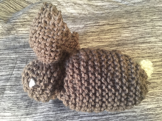 A simple garter stitch knitted square, cleverly sewn into a bunny.